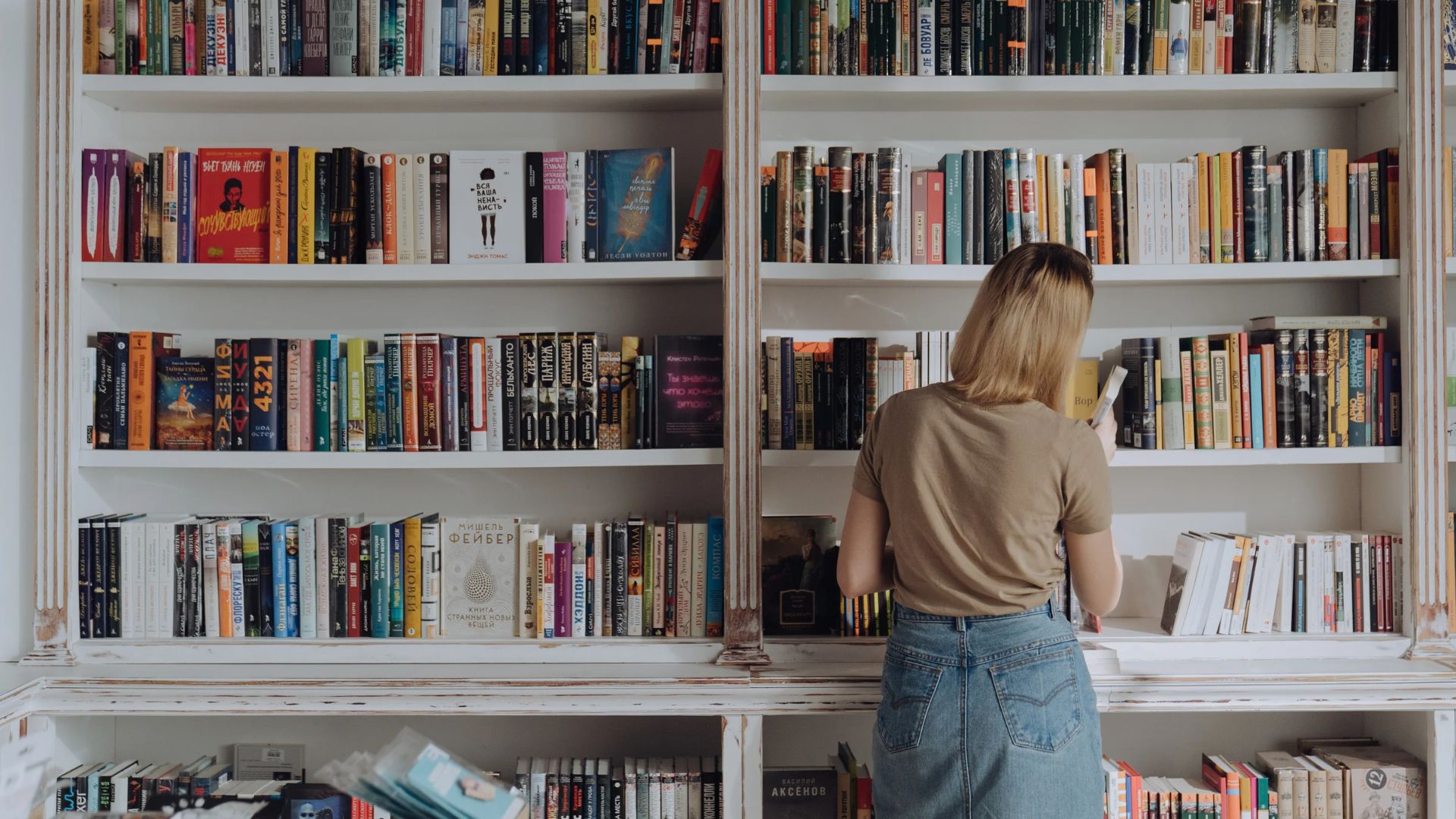 Woman in front of bookshelf