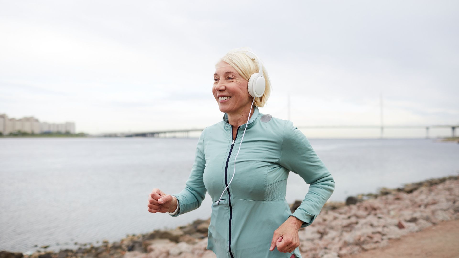 Senior woman walking with headphones