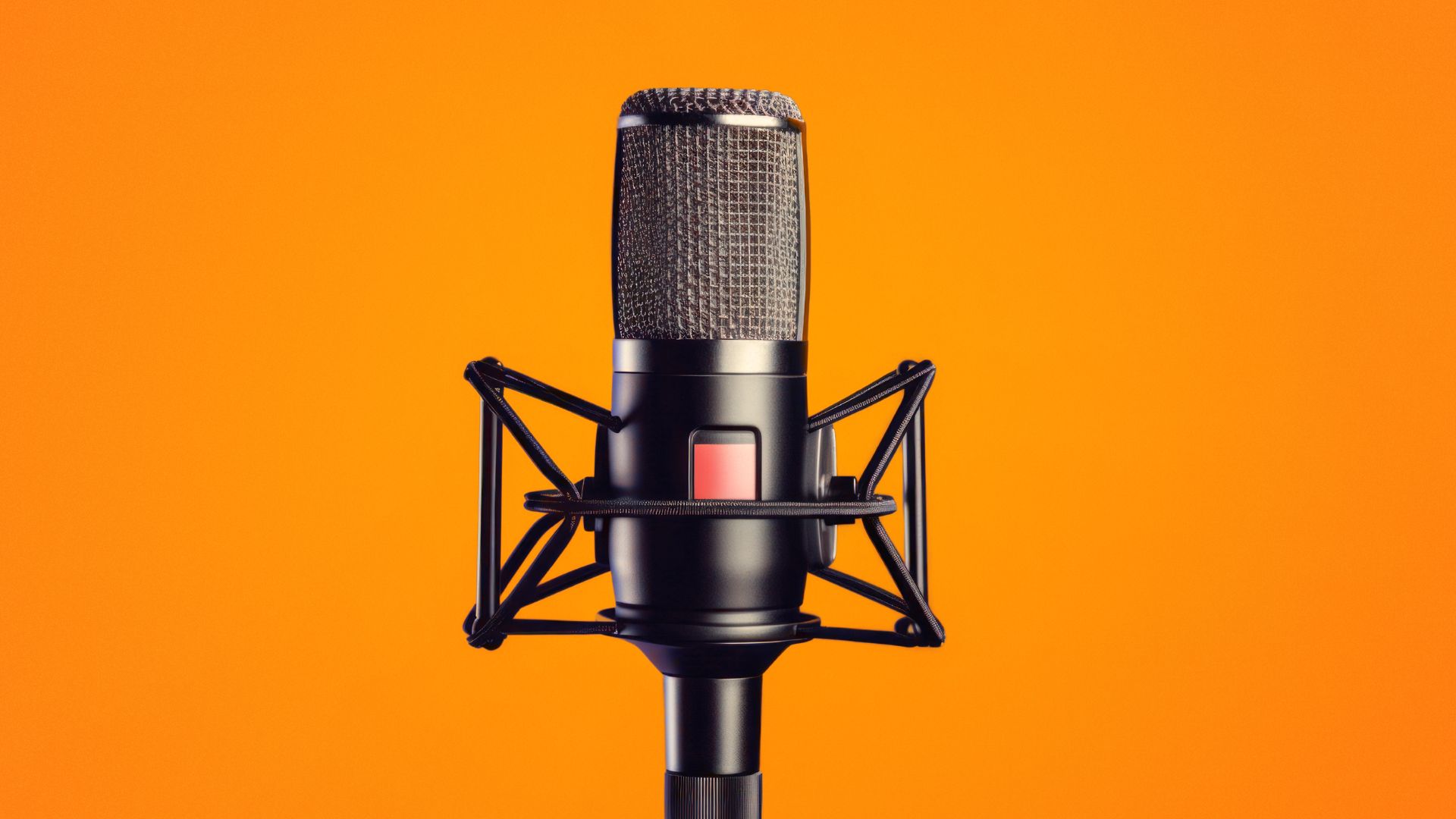 A microphone on an orange background