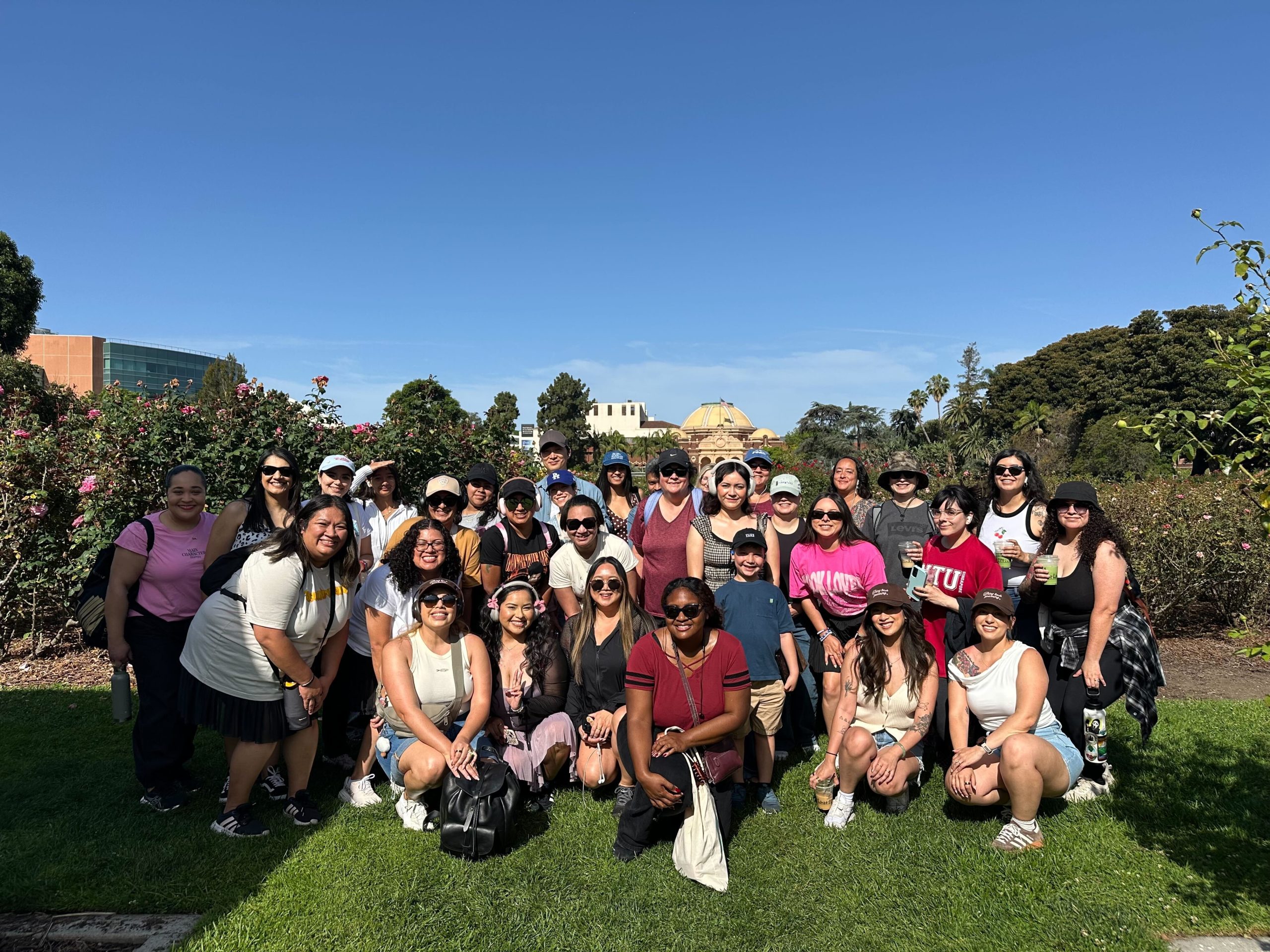 A group shot of readers in a rose garden